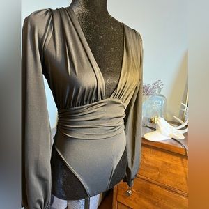 Black long sleeved blouse with plunging neckline